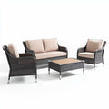 Outdoor wicker patio furniture set with beige cushions and glass table